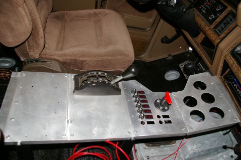 1986 Ford Bronco - Custom center console features a shifter, multiple switches, and indicator lights, suggesting aftermarket modifications.