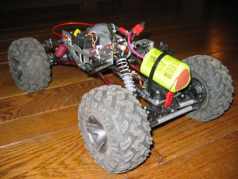 1985 Ford Bronco - Remote control truck chassis with large off-road tires and a visible Ni-Cd battery pack.