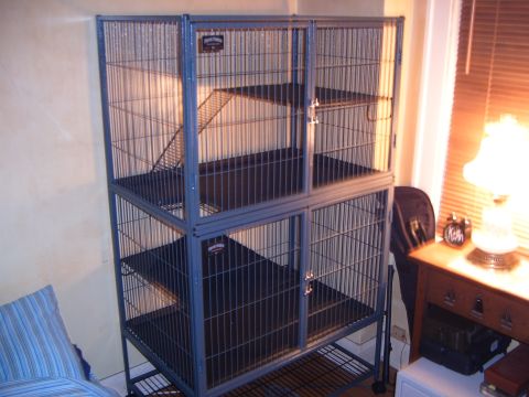 1993 Ford Bronco - A large, multi-level wire cage with black plastic trays is shown in a room setting.