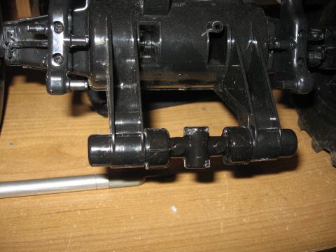 1990 Ford Bronco - Close-up view of black plastic suspension components, possibly from a model or toy vehicle.