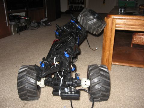 1990 Ford Bronco - Chassis of a remote control monster truck, showing suspension and drivetrain components.