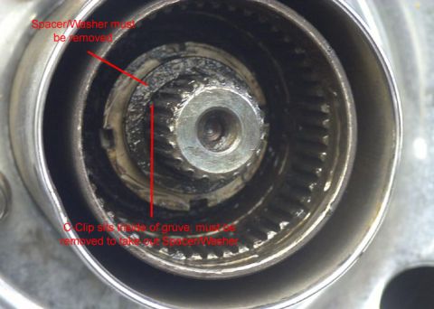 1991 Ford Bronco - This image shows a close-up of a warn hub assembly, with instructional text and arrows indicating parts to be removed.