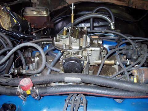 1972 Ford Ranchero - Close-up view of an engine bay, focusing on the carburetor and associated hoses and wiring. The Supermotors.net logo is visible at the bott…