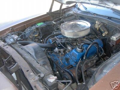 1972 Ford Ranchero - The engine bay of a vehicle, blue painted valve covers and a chrome air filter housing.