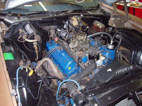 1972 Ford Ranchero - The engine compartment of a 1972 Ford Ranchero, blue valve covers and a prominent carburetor.
