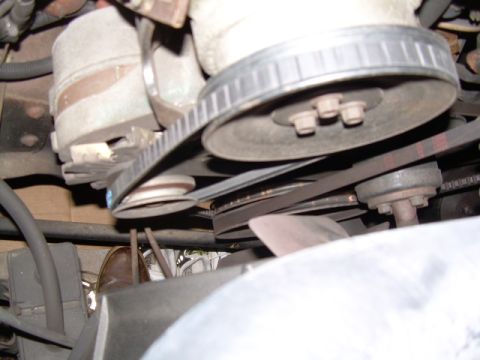 1984 Ford Bronco - The image shows a close-up view of the engine's belt system, including pulleys and belts.