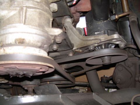 1984 Ford Bronco - Close-up view of engine pulleys and belts, showing a compressor clutch.