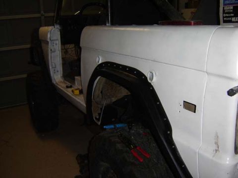 1971 Ford Bronco - Side view of a 1971 Ford Bronco undergoing restoration, showing body panels and fender flare.