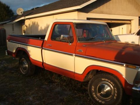 1974 Ford F-100 - This pickup truck has a two-tone paint scheme with a red body and white stripe.