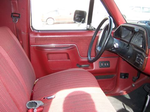 1991 Ford Bronco - Interior view of a 1991 Ford Bronco, highlighting the red upholstery and dashboard details.