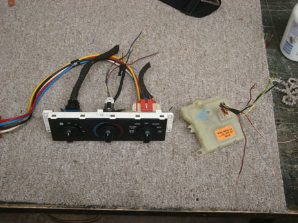 1992 Ford Crown Victoria - HVAC control panel and actuator removed from a vehicle, likely for repair or replacement.