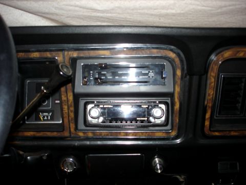 1979 Ford Bronco - The interior of a 1979 Ford Bronco features wood grain trim around the radio and climate controls.