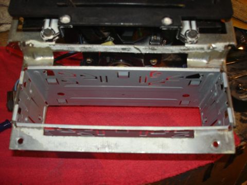 1979 Ford Bronco - This is a metal mounting bracket for a car stereo, with visible internal bracing and mounting holes.