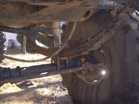 2005 Ford Excursion - Close-up view of the undercarriage of a vehicle, focusing on the suspension and tire.