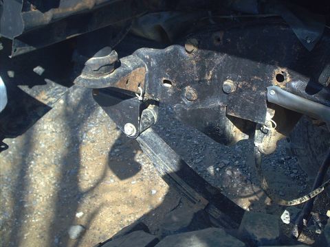 2005 Ford Excursion - Close-up view of rusted vehicle frame and suspension parts, likely from an older truck or SUV.