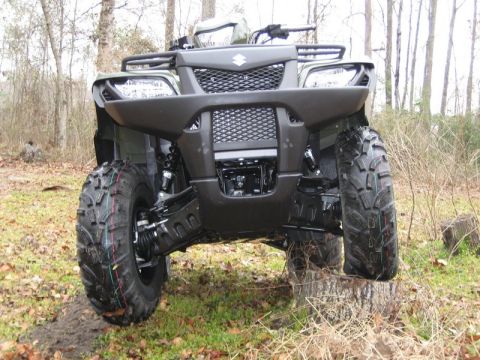 2004 Ford F-150 - A dark green Suzuki King Quad 4x4 is shown from the front, perched on a tree stump in a wooded area.