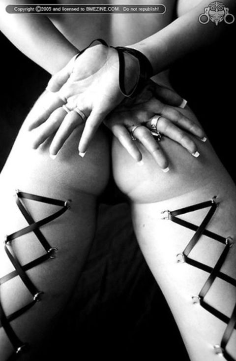 1990 Ford Bronco - Black-and-white artistic photo of a person's legs and hands with decorative ribbon corset lacing through body piercings, watermarked "Copyr…