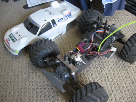 1974 Ford F-100 - Disassembled remote control monster truck with its body and chassis separated.