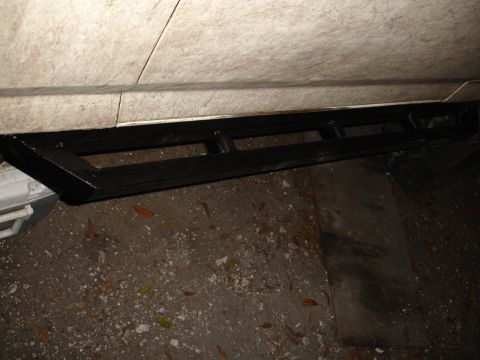 1989 Ford Bronco - Aftermarket black metal running boards installed on a vehicle's side.