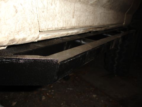 1989 Ford Bronco - Close-up of a black slider bar mounted to the side of a vehicle.