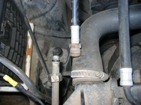 1991 Ford Bronco - Engine bay detail with various hoses and cables visible, including radiator and coolant lines.