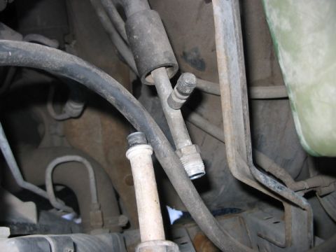 1991 Ford Bronco - This image shows various hoses and metal fittings located in the engine compartment of a vehicle.