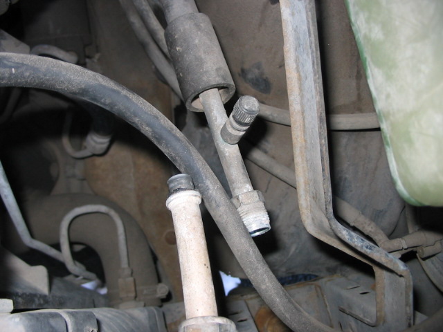 Close-up of hoses and metal fittings in a vehicle's engine bay