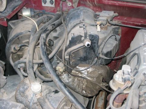1991 Ford Bronco - Close-up view of underhood components, including the heater core and associated plumbing.