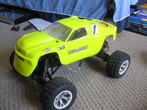 1974 Ford F-100 - This bright yellow remote control truck features "F150" and "Traxxas" branding, suggesting it is a model inspired by a Ford truck.