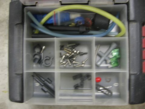 1974 Ford F-100 - A parts organizer holds various automotive components including hoses, screws, clips, and fuses.