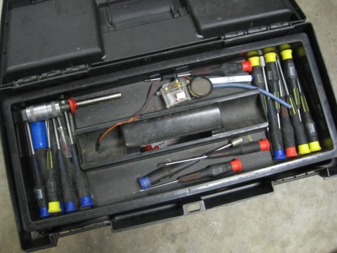 1974 Ford F-100 - A black toolbox is open, revealing a collection of precision screwdrivers and other small tools organized within its compartments.