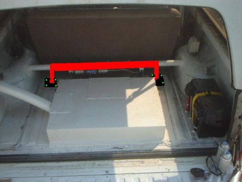 1991 Ford Bronco - The rear cargo area of a vehicle is shown with a large tank and a red roll bar installed.