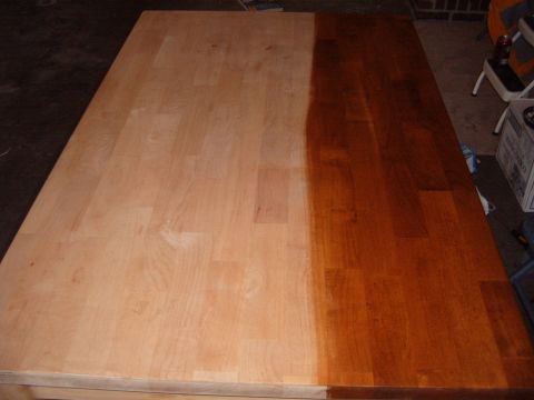 1988 Ford Bronco - Wood table surface shows progress of refinishing, with one half stained dark.