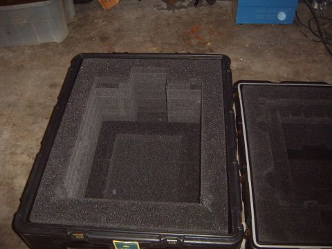 1988 Ford Bronco - Two black protective cases with custom foam inserts are shown on a concrete floor.