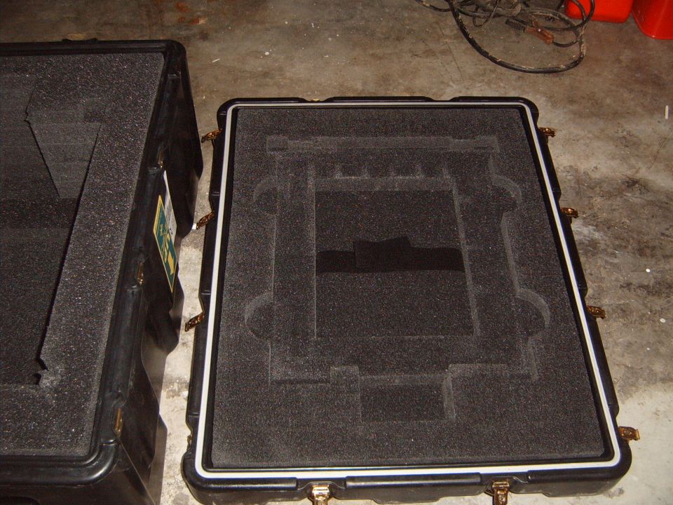 Two black protective cases with custom foam inserts
