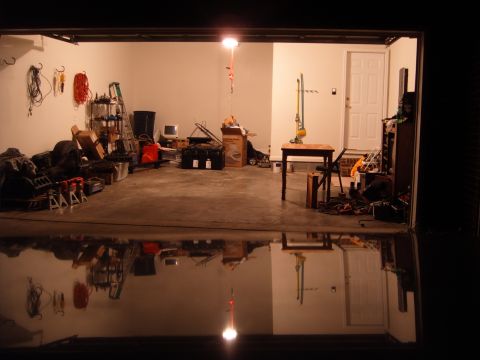 1988 Ford Bronco - Interior view of a cluttered garage with various items stored and tools on the walls.