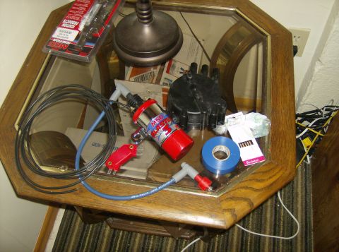 1996 Ford Probe - Automotive ignition parts including an MSD coil and distributor cap are laid out on a table.