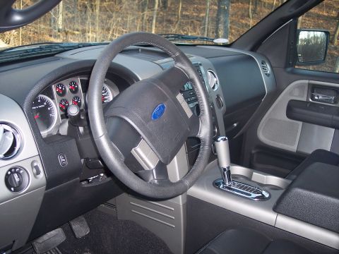 2007 Dodge Durango - The interior of a Ford F-150 truck, a dashboard with gauges and a steering wheel.