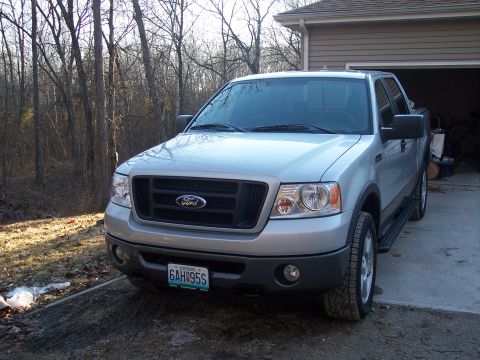2007 Dodge Durango - This silver Ford F-150 pickup truck is parked in a driveway next to a garage.