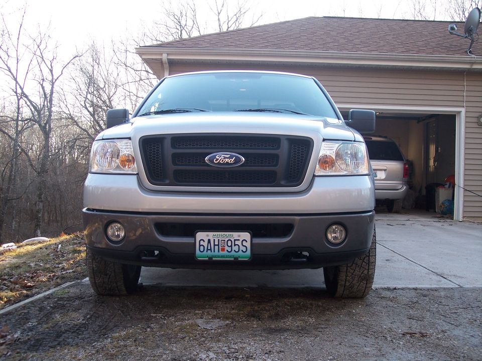 Front view of silver Ford F-150 pickup truck. Has a black grille with Ford logo and Missouri license plate