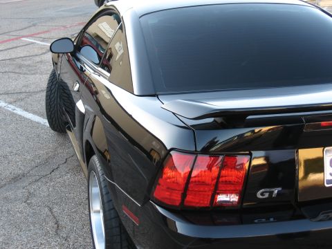 1986 Ford Bronco - Rear view of a black Ford Mustang GT, model year 2003.