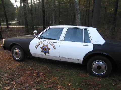 1991 Ford LTD Crown Victoria - This highway patrol car has a two-tone paint scheme and visible "HIGHWAY PATROL" lettering on the side.