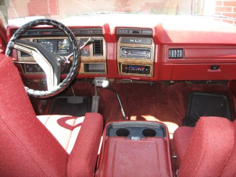 1986 Ford Bronco - Interior view of a 1986 Ford Bronco, red upholstery and an XLT trim level dashboard.