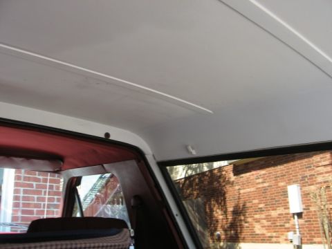 1986 Ford Bronco - Interior shot of a vehicle, showing the headliner and window frame.