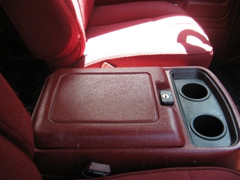 1986 Ford Bronco - Interior view of a 1986 Ford Bronco's center console, showing cup holders and storage.