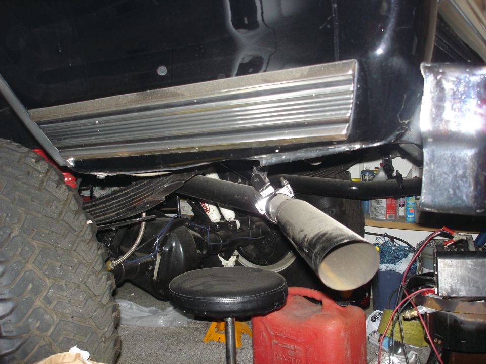 Close-up of exhaust pipe and rear axle assembly