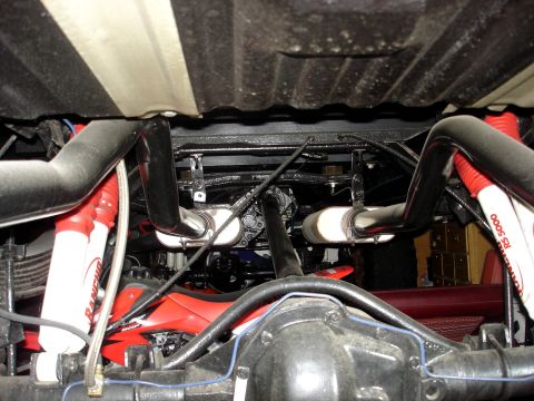 1979 Ford F-250 - The undercarriage of a truck features a dual exhaust system and bright red Rancho RS 5000 shock absorbers.