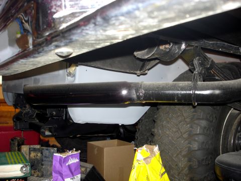 1979 Ford F-250 - Undercarriage view of a 1979 Ford F-250, showing the exhaust system and a large off-road tire.