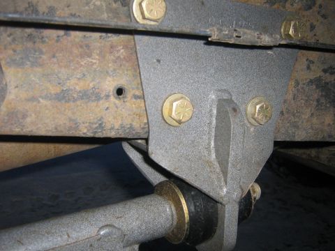1995 Ford Bronco - Detail of a vehicle's suspension system, showing a bracket and bushing assembly.