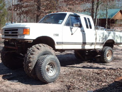 1990 Ford F-150 - This lifted Ford F-150 features oversized tires and a modified suspension system, giving it a appearance.